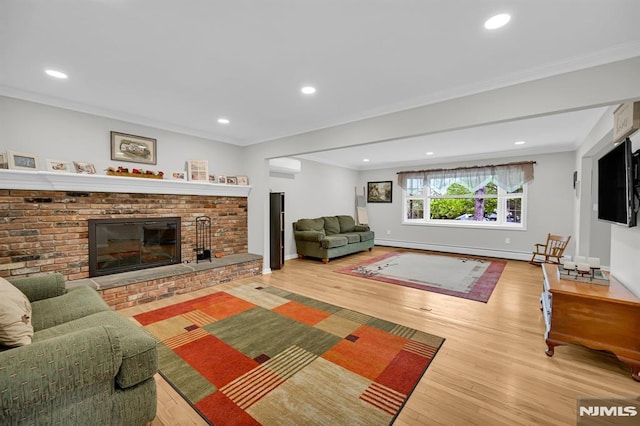 living room featuring a brick fireplace, wood finished floors, baseboards, recessed lighting, and ornamental molding