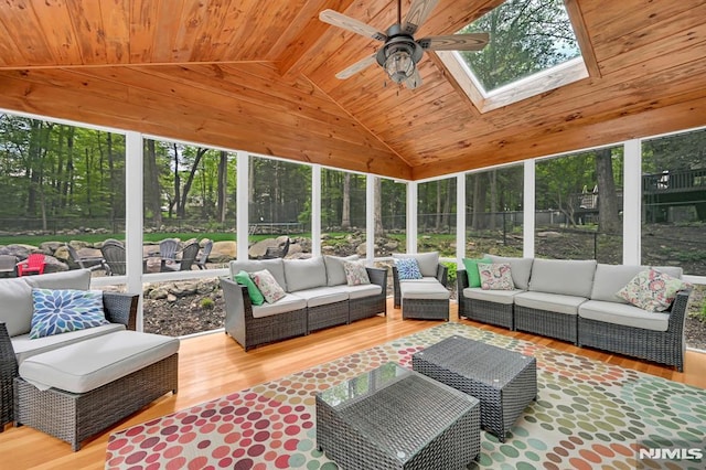 sunroom / solarium featuring outdoor lounge area, plenty of natural light, lofted ceiling, a ceiling fan, and a skylight