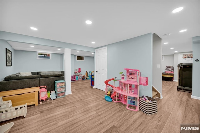 game room featuring wood finished floors, recessed lighting, and baseboards