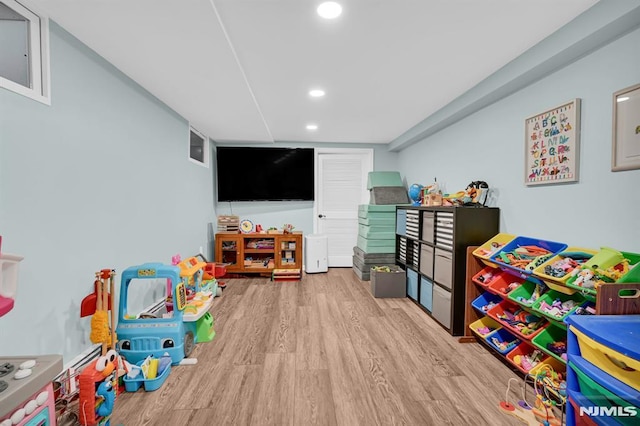 playroom featuring wood finished floors and recessed lighting
