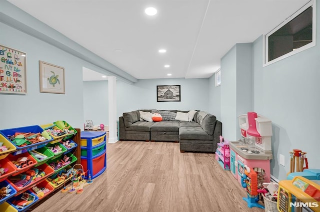 game room with wood finished floors and recessed lighting