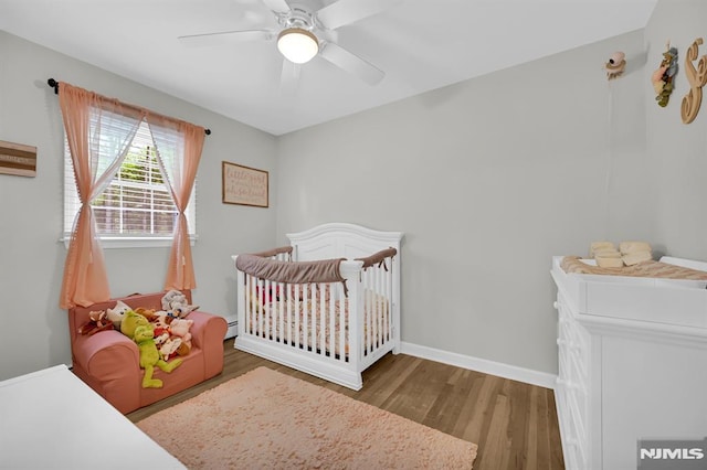 bedroom with wood finished floors, ceiling fan, and baseboards
