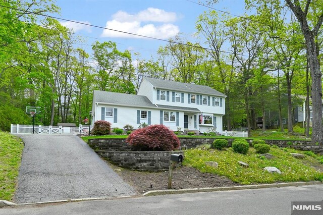 colonial house with a gate and fence