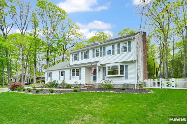 view of front of property with a chimney and a gate