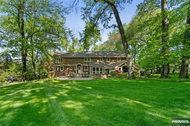 2 Canterbury Ct, Alpine, NJ 07620 - back of property with a patio and a yard