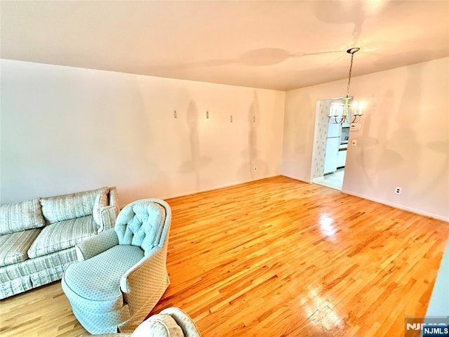 living area with wood finished floors and a chandelier