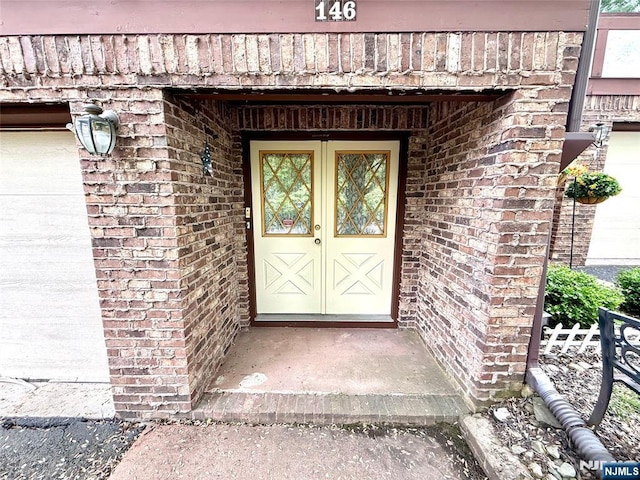 entrance to property featuring brick siding