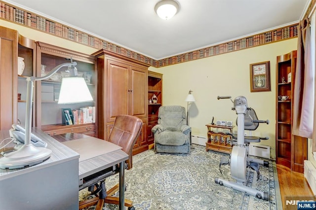 office space with baseboard heating and wood finished floors