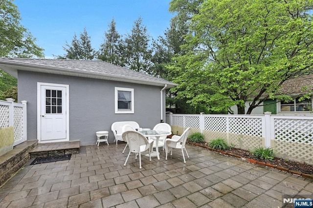 view of patio featuring fence and outdoor dining area