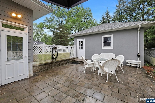 view of patio / terrace featuring fence and outdoor dining space