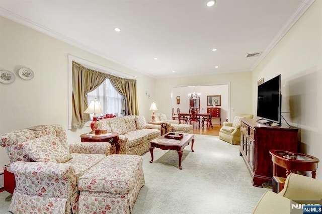living area featuring crown molding, a chandelier, and recessed lighting