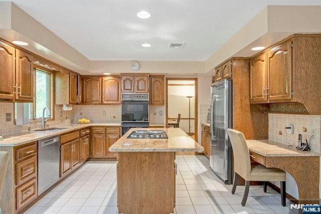 2 Morgan Ct, Montvale, NJ 07645 - kitchen featuring stainless steel appliances, tasteful backsplash, a sink, a center island, and brown cabinetry
