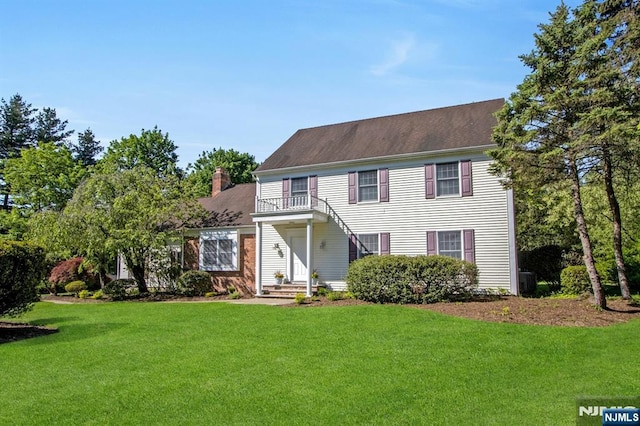 2 Morgan Ct, Montvale, NJ 07645 - colonial inspired home with a balcony, a front lawn, and a chimney