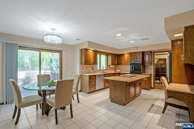 2 Morgan Ct, Montvale, NJ 07645 - kitchen with black oven, a sink, stainless steel dishwasher, light countertops, and brown cabinetry