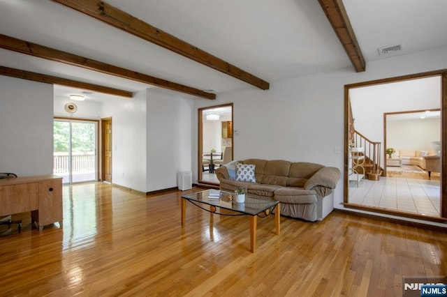 2 Morgan Ct, Montvale, NJ 07645 - living area with beamed ceiling, light wood finished floors, and stairway