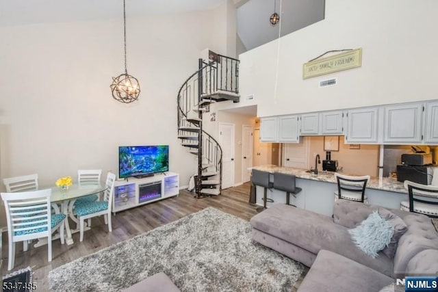 4 Winter Park Dr Unit 4, Vernon, NJ 07462 - living room with stairway, wood finished floors, high vaulted ceiling, a chandelier, and baseboards