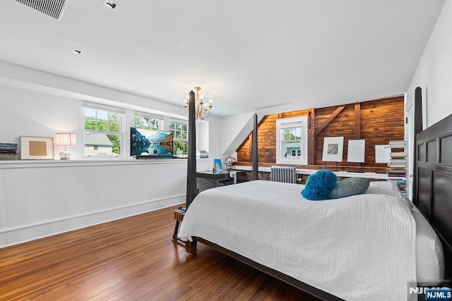 868 Goffle Rd, Hawthorne, NJ 07506 - bedroom featuring wooden walls, wood finished floors, a chandelier, and baseboards