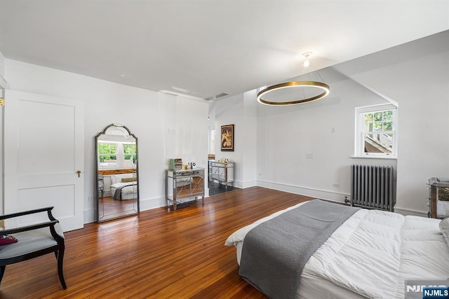 868 Goffle Rd, Hawthorne, NJ 07506 - bedroom featuring radiator heating unit, multiple windows, and wood finished floors