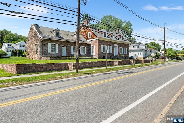 868 Goffle Rd, Hawthorne, NJ 07506 - view of front facade with stone siding, a chimney, and a residential view