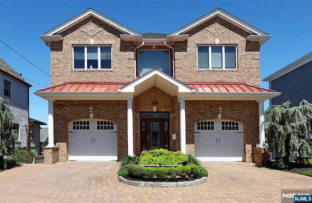 543 Page Ave, Lyndhurst, NJ 07071 - view of front of property featuring a garage, a standing seam roof, and brick siding
