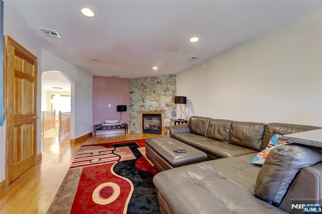 543 Page Ave, Lyndhurst, NJ 07071 - living room with light wood-style floors, arched walkways, a fireplace, recessed lighting, and baseboards
