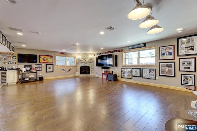 543 Page Ave, Lyndhurst, NJ 07071 - living room featuring wine cooler, baseboards, wood finished floors, a stone fireplace, and recessed lighting