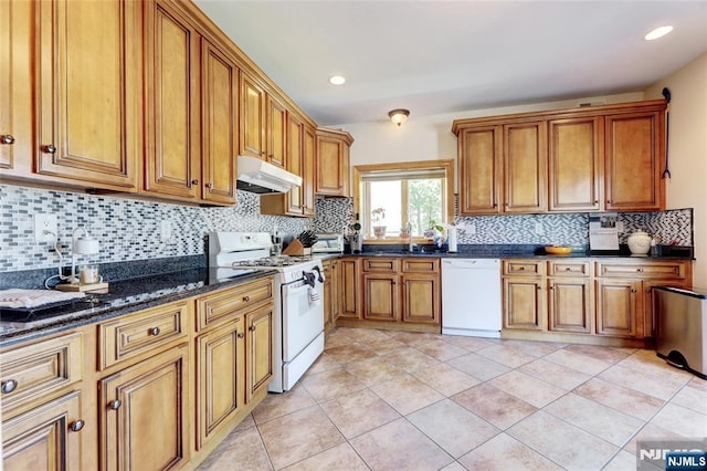 543 Page Ave, Lyndhurst, NJ 07071 - kitchen featuring white appliances, under cabinet range hood, brown cabinetry, tasteful backsplash, and recessed lighting
