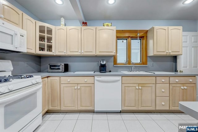 kitchen featuring white appliances, light brown cabinetry, a sink, light tile patterned floors, and recessed lighting