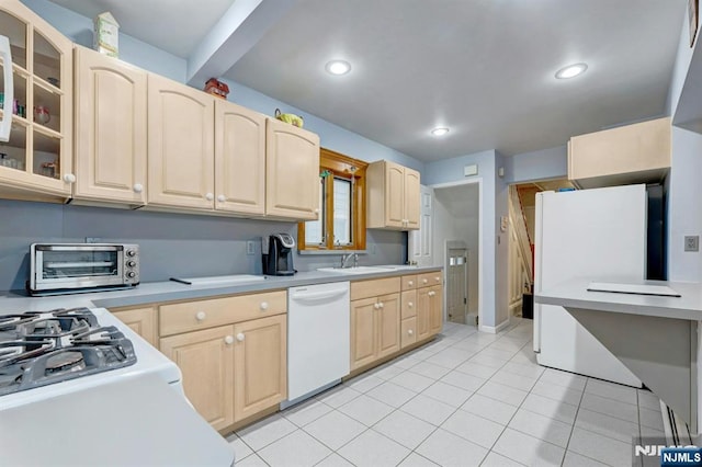 kitchen featuring white dishwasher, light brown cabinets, a sink, light countertops, and glass insert cabinets