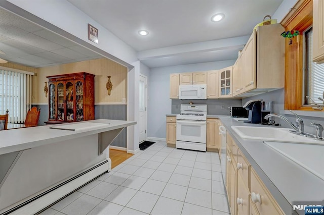 kitchen with white appliances, a baseboard heating unit, light brown cabinets, glass insert cabinets, and light countertops