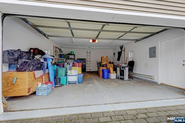 garage featuring a garage door opener, baseboard heating, and electric panel