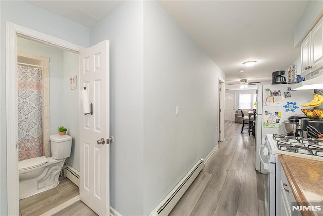20 Park Dr, Oakland, NJ 07436 - hallway featuring a baseboard radiator, light wood-style flooring, and baseboards