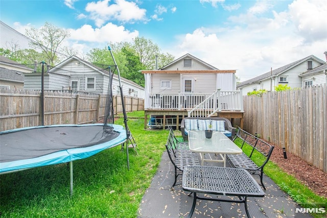 20 Park Dr, Oakland, NJ 07436 - back of property with a trampoline, outdoor dining area, a wooden deck, and stairway