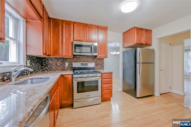 38 Pitcairn Ave, Ho-Ho-Kus, NJ 07423 - kitchen with stainless steel appliances, a sink, decorative backsplash, and light stone countertops