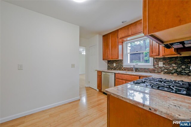 38 Pitcairn Ave, Ho-Ho-Kus, NJ 07423 - kitchen with dishwasher, a sink, light wood-type flooring, backsplash, and baseboards