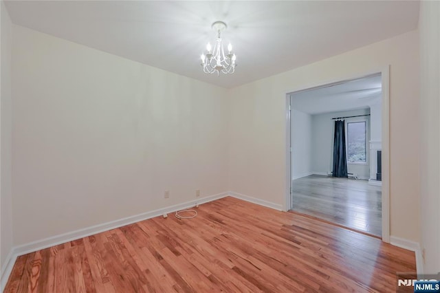 38 Pitcairn Ave, Ho-Ho-Kus, NJ 07423 - empty room with a chandelier, light wood finished floors, and baseboards