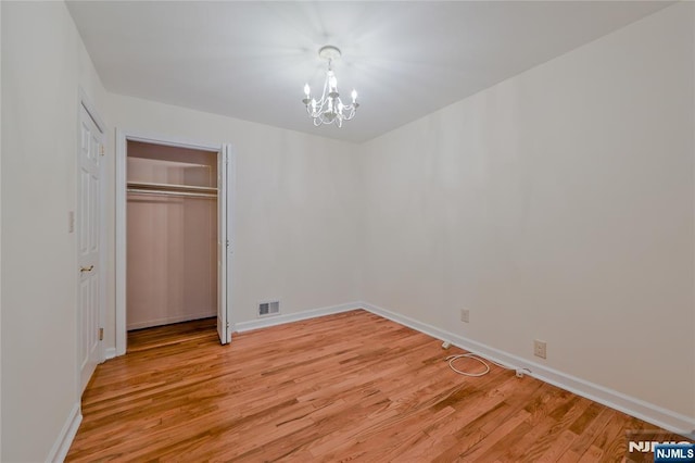 38 Pitcairn Ave, Ho-Ho-Kus, NJ 07423 - unfurnished bedroom with a chandelier, light wood finished floors, baseboards, and a closet