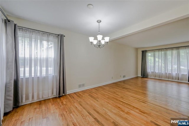38 Pitcairn Ave, Ho-Ho-Kus, NJ 07423 - empty room with a chandelier, light wood-type flooring, and baseboards
