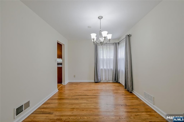 38 Pitcairn Ave, Ho-Ho-Kus, NJ 07423 - empty room with a chandelier, light wood-style floors, and baseboards