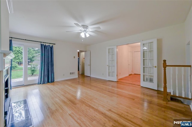 38 Pitcairn Ave, Ho-Ho-Kus, NJ 07423 - unfurnished living room with french doors, ceiling fan, light wood-type flooring, a fireplace, and baseboards