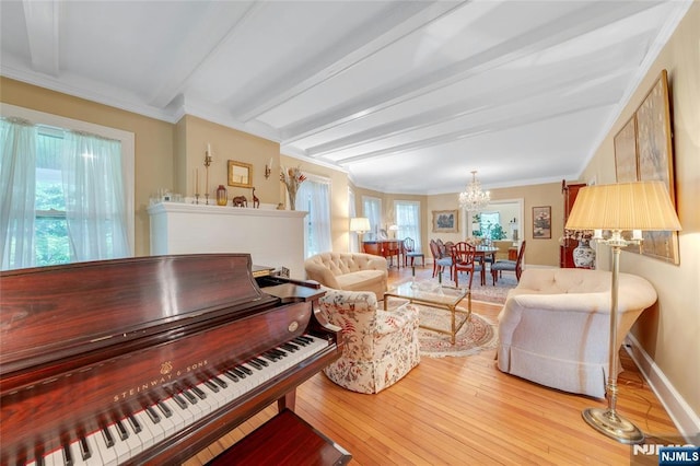 living area with a chandelier, beam ceiling, hardwood / wood-style floors, crown molding, and baseboards