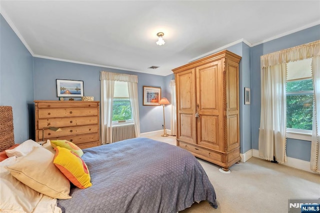 bedroom with baseboards, light colored carpet, and crown molding