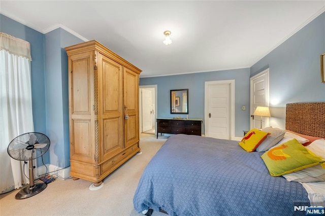 bedroom with light colored carpet, crown molding, and baseboards