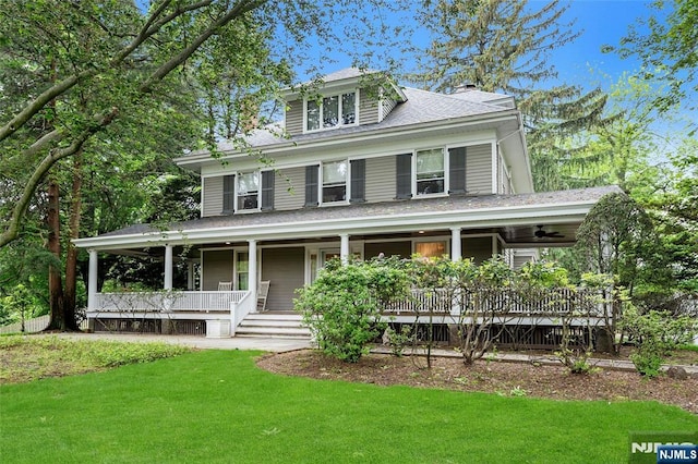 view of front of property with a porch and a front lawn