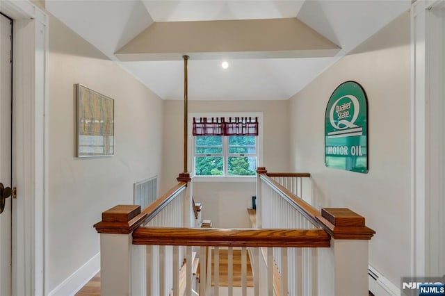 staircase with baseboard heating, baseboards, and wood finished floors