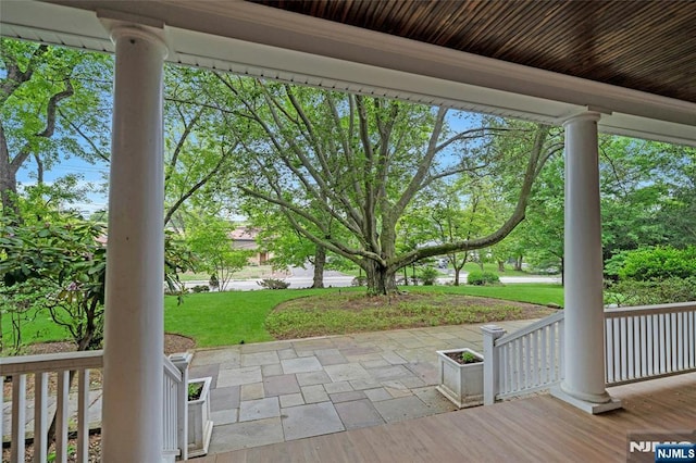 deck featuring a porch and a yard