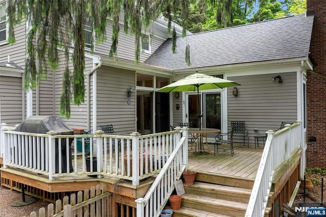wooden terrace with grilling area, outdoor dining space, and stairway