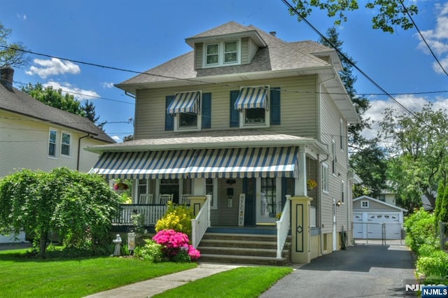 38 Arlington Ave, Hawthorne, NJ 07506 - traditional style home featuring covered porch, a detached garage, an outdoor structure, a front yard, and a shingled roof