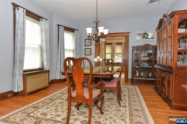 38 Arlington Ave, Hawthorne, NJ 07506 - dining room with a chandelier, healthy amount of natural light, light wood finished floors, and radiator