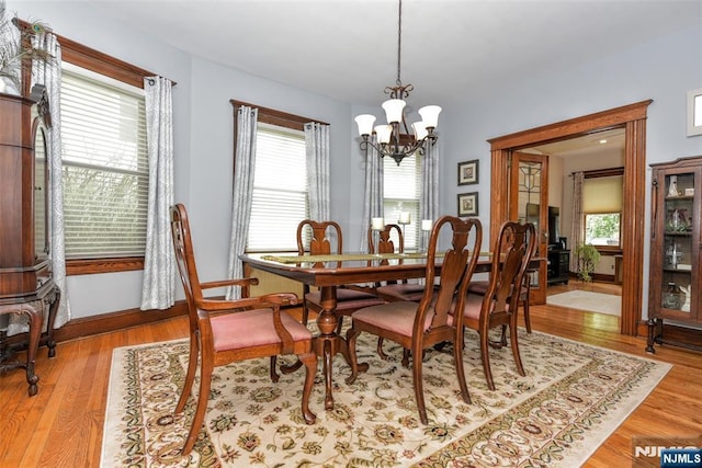 38 Arlington Ave, Hawthorne, NJ 07506 - dining space featuring a chandelier, wood finished floors, and baseboards